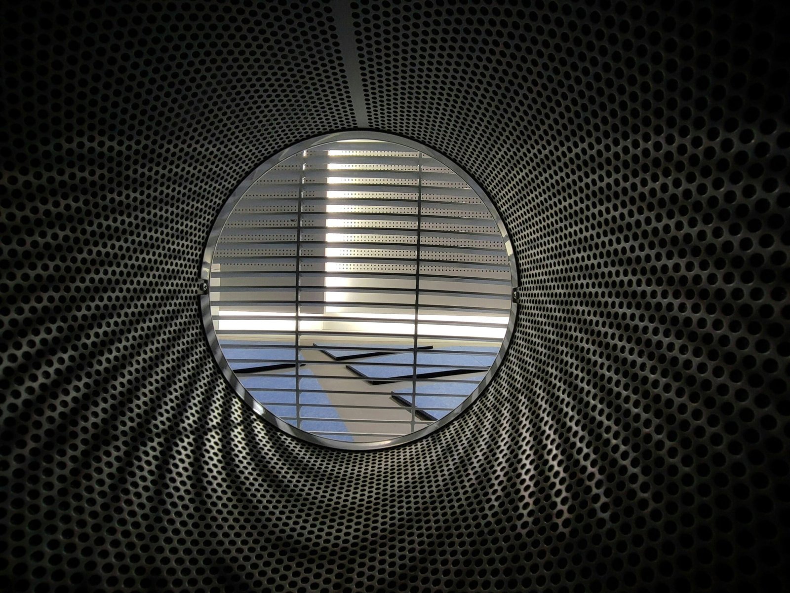 an airplane is seen through a circular window